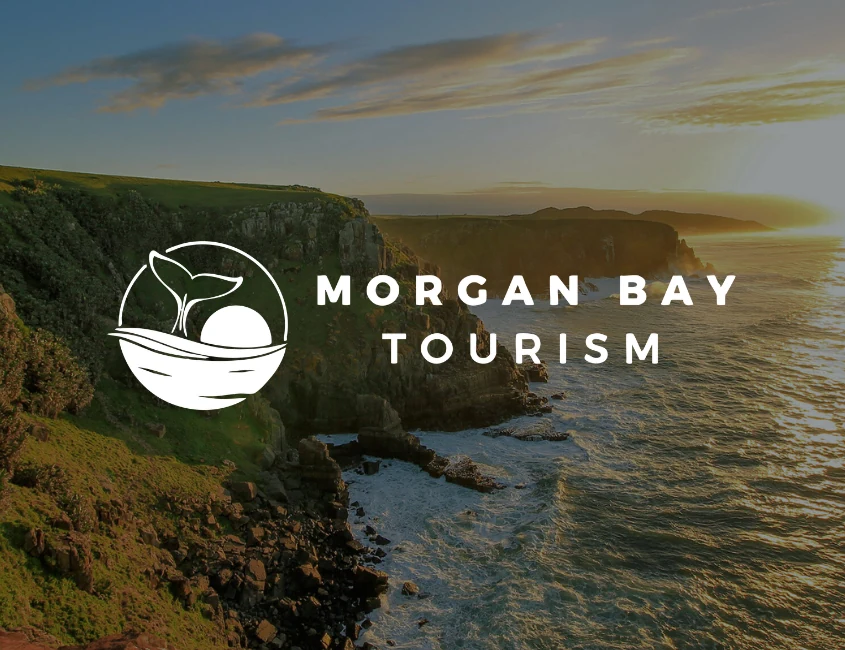 Morgan Bay Tourism logo over sunset cliffs on the Wild Coast